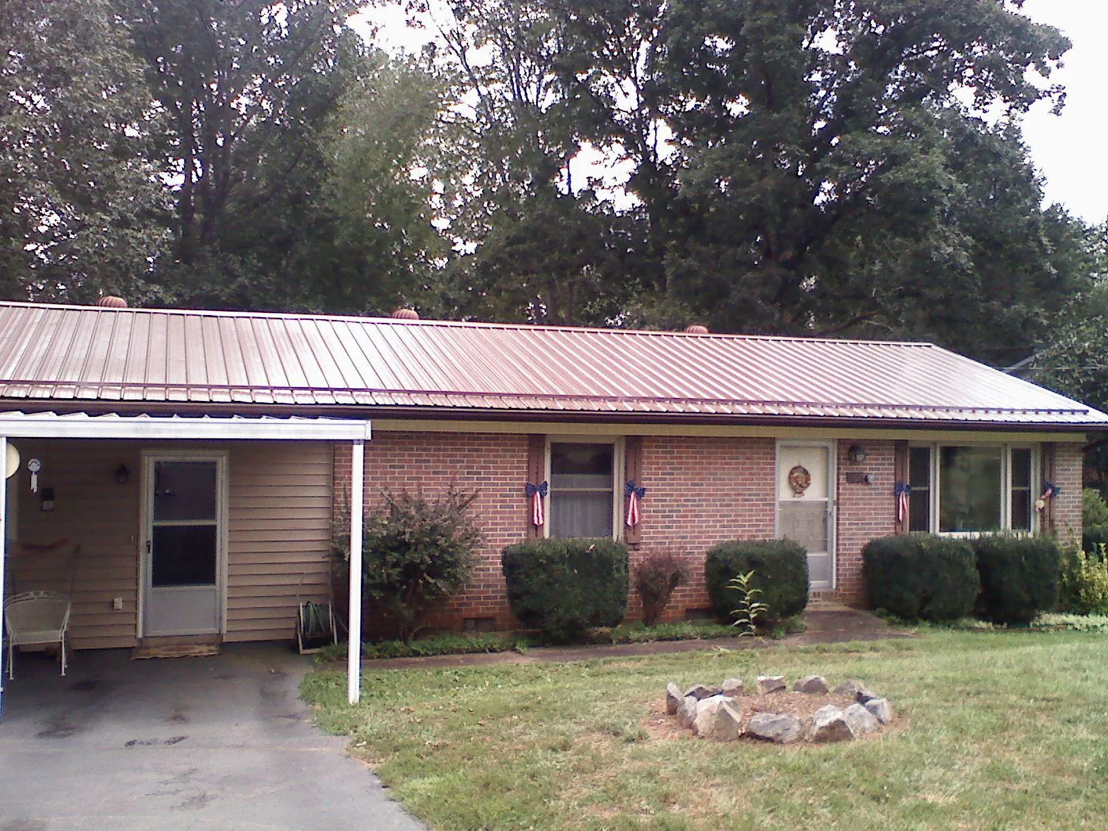 Bronze metal roof and carport on a brick ranch home — Roof Repair work by our crew in Decatur